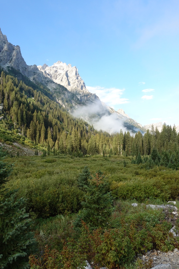 Clouds sitting under the Teton peaks