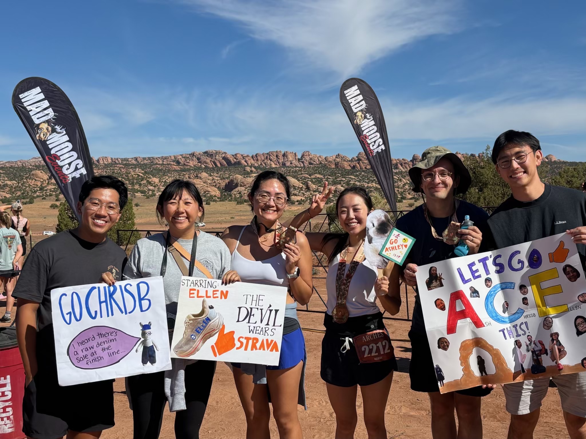 Friends holding signs at the Arches Trail Half Marathon